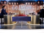 French President Emmanuel Macron, candidate for his re-election, and French far-right Rassemblement National party presidential candidate Marine Le Pen sit prior to taking part in a French presidential election debate, in Saint-Denis, north of Paris.