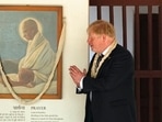 British Prime Minister Boris Johnson pays respect to Mahatma Gandhi during a visit to Gandhi Ashram in Ahmedabad.