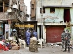 Paramilitary force stand guard at an alley after Wednesday's demolition of illegal encroachments in Jahangirpuri, in New Delhi.