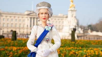 The picture sees the doll wearing an elegant ivory gown with a blue sash. Her regal ensemble is completed with a stunning tiara based on Queen Mary's Fringe Tiara, which Queen Elizabeth II wore for her wedding to Prince Philip, and matching accessories. (AFP) The picture sees the doll wearing an elegant ivory gown with a blue sash. Her regal ensemble is completed with a stunning tiara based on Queen Mary's Fringe Tiara, which Queen Elizabeth II wore for her wedding to Prince Philip, and matching accessories. (AFP)