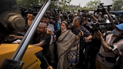 Brinda Karat in front of a bulldozer during the demolition of shops in New Delhi's Jahangirpuri in New Delhi on Wednesday. (AP) Brinda Karat in front of a bulldozer during the demolition of shops in New Delhi's Jahangirpuri in New Delhi on Wednesday. (AP)