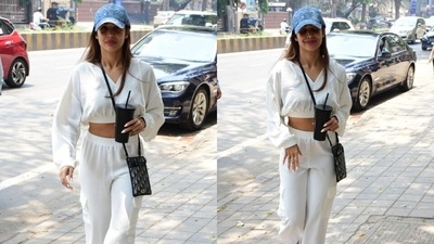 On Thursday, paparazzi clicked Malaika out and about on the Mumbai streets. They clicked the diva smiling and waving at the cameras. She looked stunning in a breezy all-white cropped sweatshirt and joggers set that deserve a special place in your summer essentials mood board. (HT Photo/Varinder Chawla) On Thursday, paparazzi clicked Malaika out and about on the Mumbai streets. They clicked the diva smiling and waving at the cameras. She looked stunning in a breezy all-white cropped sweatshirt and joggers set that deserve a special place in your summer essentials mood board. (HT Photo/Varinder Chawla)