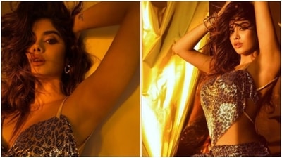 Janhvi Kapoor raised the glam quotient as she struck some sultry poses in a shimmery metallic animal print co-ord set for a photoshoot.&nbsp; (Instagram/@chandiniw)