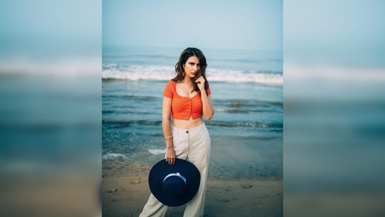 Fatima Sana Shaikh's outfit comprised of a vibrant orange cropped vest and high-rise linen trousers.(Instagram/@lakshetamodgil)
