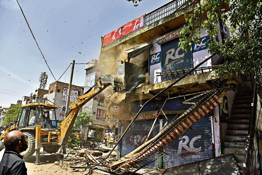 A bulldozer demolishes the structure during the anti-encroachment drive following the violence between two groups during the Hanuman Jayanti procession on April 16, at Jahangirpuri, in New Delhi on Wednesday, April 20, 2022. (ANI Photo/Rahul Singh) A bulldozer demolishes the structure during the anti-encroachment drive following the violence between two groups during the Hanuman Jayanti procession on April 16, at Jahangirpuri, in New Delhi on Wednesday, April 20, 2022. (ANI Photo/Rahul Singh)