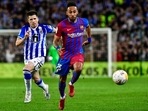 Barcelona's Pierre-Emerick Aubameyang, right, runs for the ball during a Spanish La Liga soccer match between Real Sociedad and FC Barcelona at the Reale Arena stadium in San Sebastian, Spain.