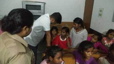 Basic education officer (BSA) Dr Laxmi Kant Pandey talking to the girl students of KGBV Behjam on Thursday night after they were allegedly held hostage by two woman teachers. (HT photo)
