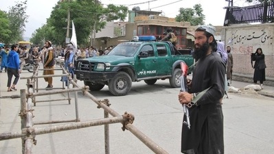 Taliban fighters stand guard at the site of an explosion in Kabul, Afghanistan, April 19. (REUTERS file)