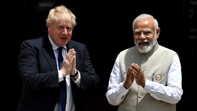 British Prime Minister Boris Johnson and his Indian counterpart Narendra Modi gesture before their meeting at the Hyderabad House in New Delhi. (REUTERS)