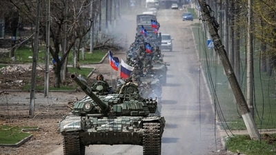 An armoured convoy of pro-Russian troops moves along a road during Ukraine-Russia conflict in the southern port city of Mariupol. (Reuters)