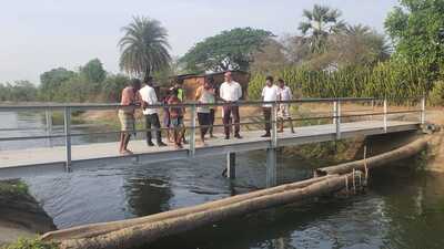 Vaibhav Sankhe (in white) with villagers on the new bridge. (HT PHOTO) Vaibhav Sankhe (in white) with villagers on the new bridge. (HT PHOTO)