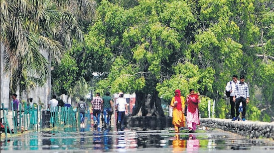 A mirage appears on the walkway at Sukhna Lake in Chandigarh amid scorching weather on Friday. The day temperature rose by four degrees after the cloudy weather subsided. (Ravi Kumar/HT)