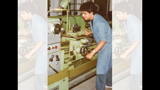 Operating a lathe machine during a college workshop