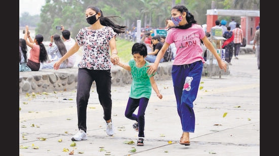 Children delighted by the cool weather after the drizzle at Sukhna Lake in Chandigarh on Thursday. (Keshav Singh/HT)