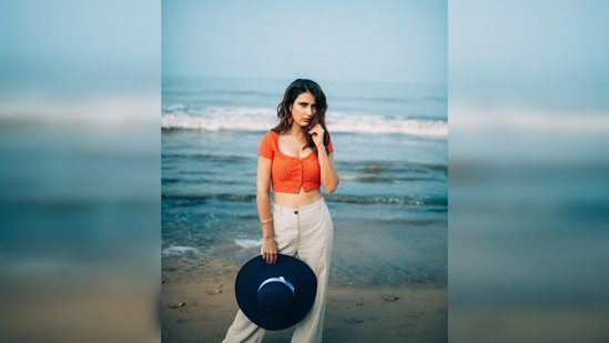 Fatima Sana Shaikh's outfit comprised of a vibrant orange cropped vest and high-rise linen trousers.(Instagram/@lakshetamodgil)