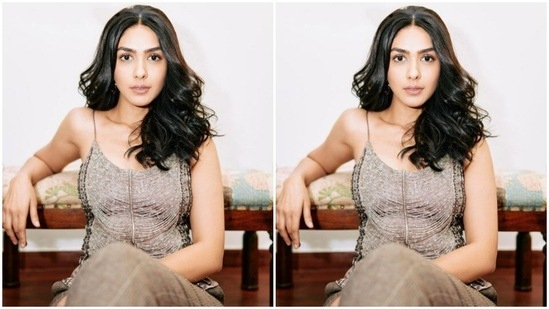 Mrunal decked up in a light maroon satin slip-in top with midriff-baring details and intricate details in beads and resham threads. She teamed it with a pair of light maroon checkered formal trousers.(Instagram/@mrunalthakur)
