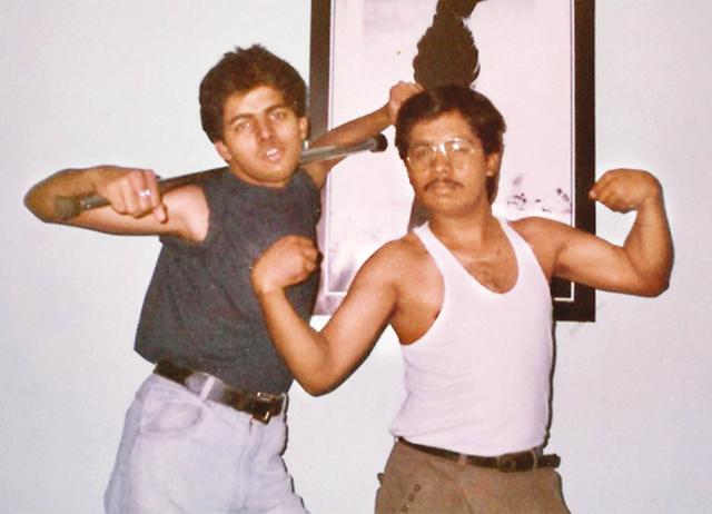 Flexing his muscles with his brother in front of an iconic Michael Jackson poster Flexing his muscles with his brother in front of an iconic Michael Jackson poster