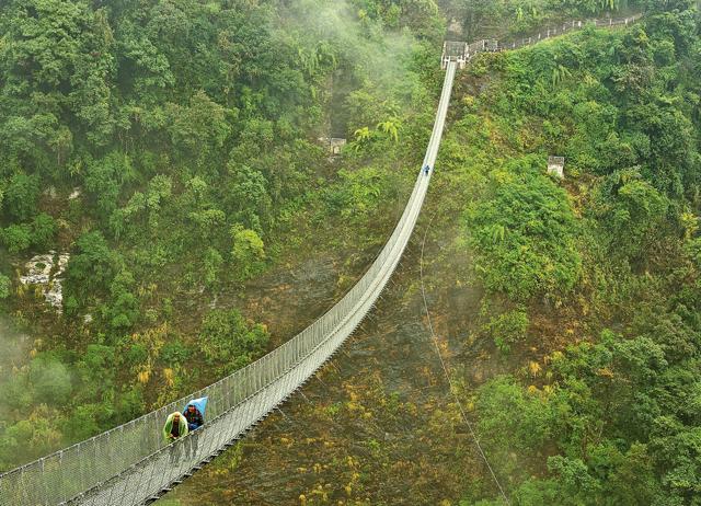 The suspension bridge from the road head to Jhinu Danda over Kimrong Khola
