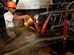 A worker checks the quality of crude palm oil (CPO) in a state CPO processing unit at Indonesia's North Sumatra province May, 2012. REUTERS/Tarmizy Harva