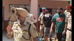 The Punjab Police team with the accused in Una on Saturday. The accused had hidden the explosive in a well in a forest adjoining the village on the Himachal Pradesh-Punjab border. (HT Photo) The Punjab Police team with the accused in Una on Saturday. The accused had hidden the explosive in a well in a forest adjoining the village on the Himachal Pradesh-Punjab border. (HT Photo)
