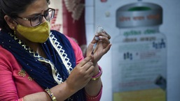 A healthworker fills a syringe with a dose of Covid-19 vaccine before administering it to a beneficiary, in New Delhi.&nbsp;