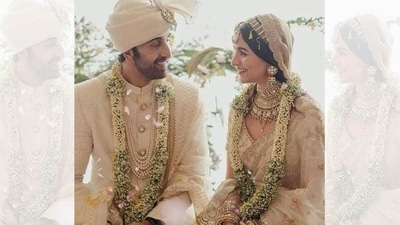 Alia Bhatt and Ranbir Kapoor twinned in ivory wedding attires. Alia Bhatt donned a hand-dyed ivory organza sari embroidered with tilla work and an embroidered handwoven tissue veil by Sabyasachi while Ranbir complemented Alia in an embroidered silk Sabyasachi sherwani that featured uncut diamond buttons, a silk organza safa and teamed it with a shawl decked in zari embroidery. (Instagram/@aliaabhatt) Alia Bhatt and Ranbir Kapoor twinned in ivory wedding attires. Alia Bhatt donned a hand-dyed ivory organza sari embroidered with tilla work and an embroidered handwoven tissue veil by Sabyasachi while Ranbir complemented Alia in an embroidered silk Sabyasachi sherwani that featured uncut diamond buttons, a silk organza safa and teamed it with a shawl decked in zari embroidery. (Instagram/@aliaabhatt)