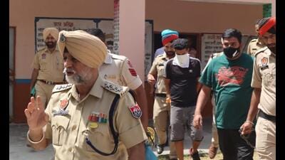 The Punjab Police team with the accused in Una on Saturday. The accused had hidden the explosive in a well in a forest adjoining the village on the Himachal Pradesh-Punjab border. (HT Photo)