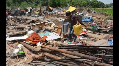 A boy recovers his belongings following the demolition drive in Chandigarh’s Kishangarh area on Saturday. (Sant Arora)