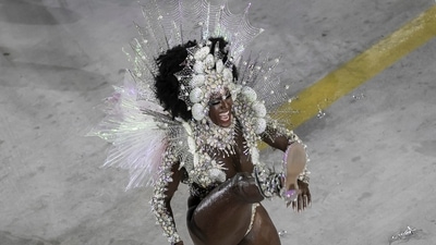 Ketula Melo, 38, a muse in the Imperatriz Leopoldinense school dressed as the Iemanja deity of Afro-Brazilian religions, was thrilled to be back at the Sambadrome. “These two years were horrible. Now we can be happy again,” Melo told AP as she was about to enter Friday night wearing a black and white costume made of shells. ((AP Photo/Bruna Prado)) Ketula Melo, 38, a muse in the Imperatriz Leopoldinense school dressed as the Iemanja deity of Afro-Brazilian religions, was thrilled to be back at the Sambadrome. “These two years were horrible. Now we can be happy again,” Melo told AP as she was about to enter Friday night wearing a black and white costume made of shells. ((AP Photo/Bruna Prado))