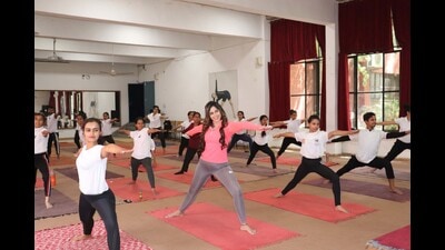 Students of Chandigarh Yoga College performing asanas during a session on Saturday. (HT Photo)