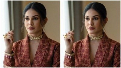 Styled by fashion stylist Malvika Tater, Amyra tied her tresses at the back with a middle part and decked up in nude eyeshadow, black eyeliner, mascara-laden eyelashes, black kohl, drawn eyebrows, contoured cheeks and a shade of maroon lipstick. (Instagram/@amyradastur93)