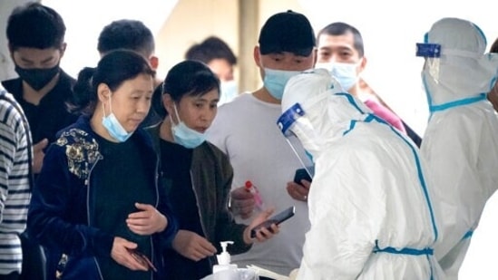 People register for COVID-19 tests at a coronavirus testing facility in Beijing, Saturday. (AP Photo/Mark Schiefelbein)(AP)