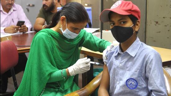 A student getting jabbed during a special vaccination camp at GMSSS, Sector 45, in Chandigarh. (Keshav Singh/HT)