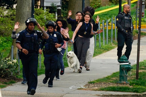 Police evacuate people near the scene of a shooting Friday, April 22, 2022, in northwest Washington. (AP Photo/Carolyn Kaster) Police evacuate people near the scene of a shooting Friday, April 22, 2022, in northwest Washington. (AP Photo/Carolyn Kaster)