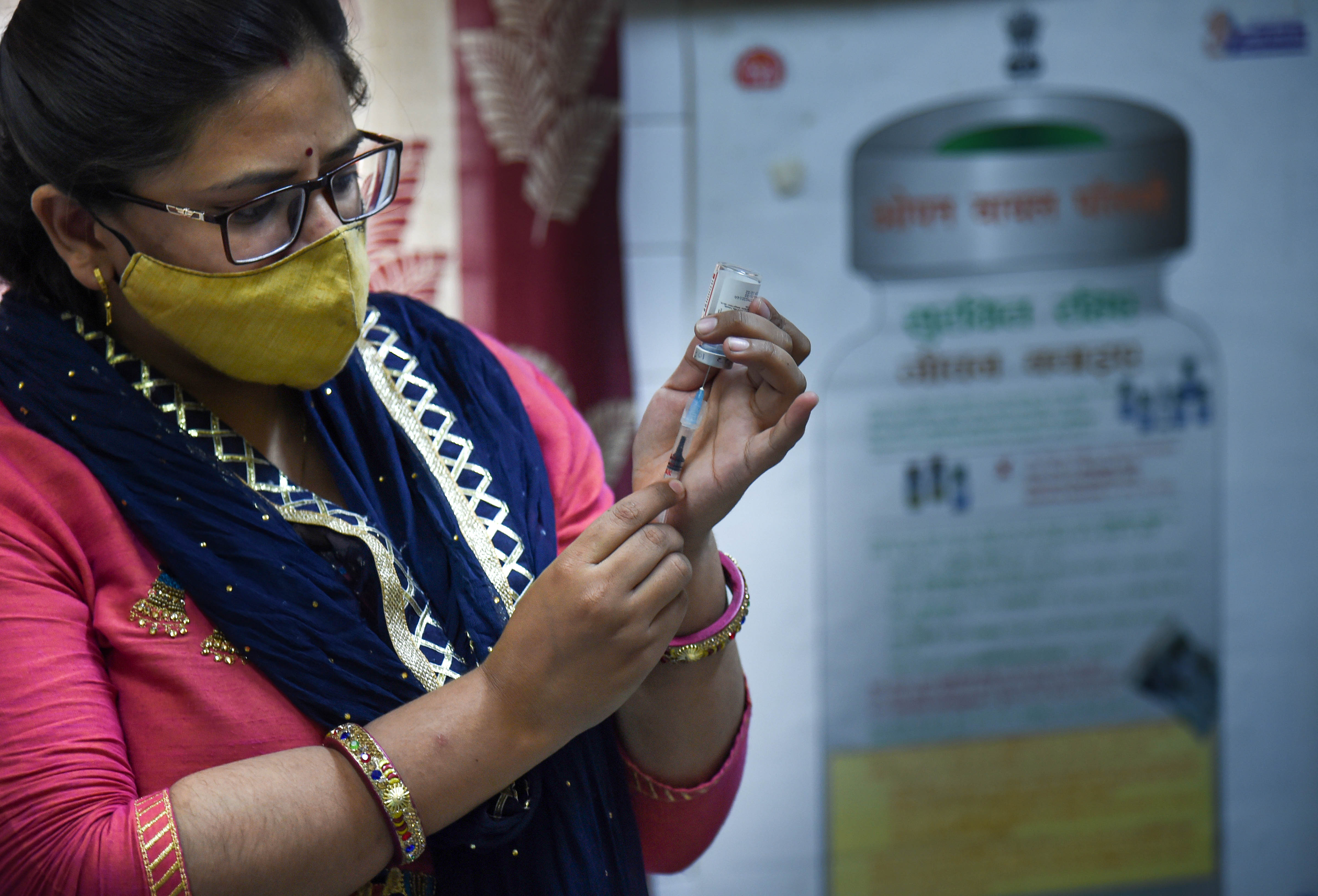 A healthworker fills a syringe with a dose of Covid-19 vaccine before administering it to a beneficiary, in New Delhi. (PTI) A healthworker fills a syringe with a dose of Covid-19 vaccine before administering it to a beneficiary, in New Delhi. (PTI)