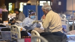 A patient being attended by a healthcare worker in Delhi Covid-19 care facility.