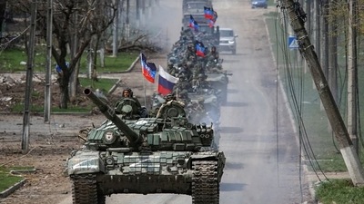 An armoured convoy of pro-Russian troops moves along a road during Ukraine-Russia conflict in the southern port city of Mariupol. (Reuters)