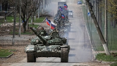 An armoured convoy of pro-Russian troops moves along a road during Ukraine-Russia conflict in the southern port city of Mariupol. (Reuters)