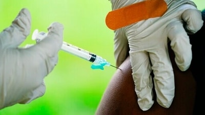  A health worker administers a dose of the Covid-19 vaccine. (AP) A health worker administers a dose of the Covid-19 vaccine. (AP)