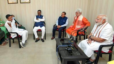 **EDS: HANDOUT PHOTO MADE AVAILABLE FROM PIB ON SUNDAY, APRIL 24, 2022.** Samba: Prime Minister Narendra Modi interacts with the Panchayat members of Samba district, Sunday, April 24, 2022. Union Minister Jitendra Singh and J&K Lt. Governor Manoj Sinha are also seen. (PTI Photo)(PTI04_24_2022_000214B) (PTI)