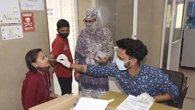 A health worker conducts a Covid test at MMG Hospital in Ghaziabad on Saturday. (Sakib Ali/ HT) A health worker conducts a Covid test at MMG Hospital in Ghaziabad on Saturday. (Sakib Ali/ HT)