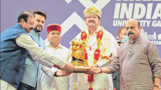 Vice President of India M. Venkaiah Naidu (C) receives a momento from sports and youth affairs minister, Anurag Singh Thakur (2L), Karnataka Governor, Thaawar Chand Gehlot (3L), and Chief Minister, Basavaraj Bommai (R) during the opening ceremony of “Khelo India University Games 2021,” at the Kanteerava Indoor Stadium in Bangalore on April 24, 2022. (Photo by Manjunath Kiran / AFP) (AFP)