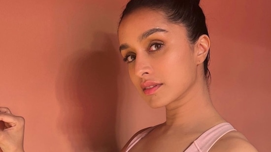 The pictures featured Shraddha donning a soft pastel pink sports bra that came with three white stripes in the centre. It was teamed with a pair of white tights and Shraddha pulled back her luscious tresses into a top knot to ace the sporty look.&nbsp;(Instagram/shraddhakapoor)