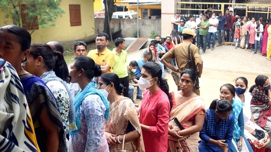 Voters wait in queues to cast their votes for the Guwahati Municipal Corporation (GMC) elections, at a polling station, in Guwahati on Friday. (ANI Photo)