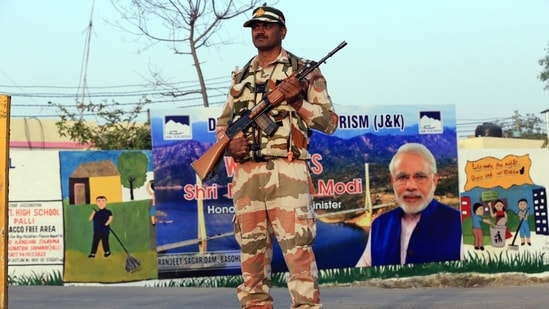 A paramilitary personnel stands guard near the venue of Prime Minister Narendra Modi's upcoming visit on April 24 at Palli village of Samba, in Jammu.(HT Photo)