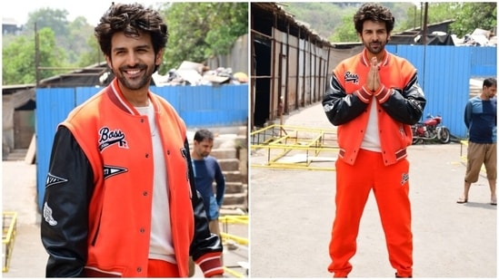 Kartik complemented Kiara in an all-orange look. The actor wore a printed jersey jacket with ribbed collars, hem and cuffs, long black leather sleeves, droopy shoulders, and a loose silhouette. He donned it over a white round neck T-shirt.(HT Photo/Varinder Chawla)