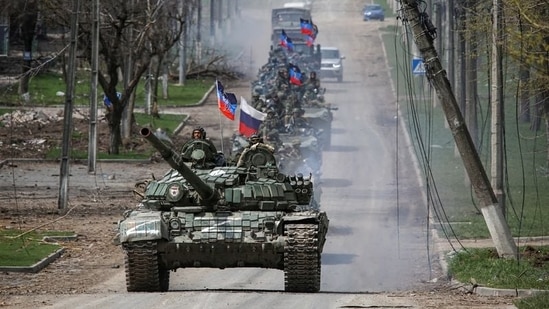 An armoured convoy of pro-Russian troops moves along a road during Ukraine-Russia conflict in the southern port city of Mariupol.(Reuters)