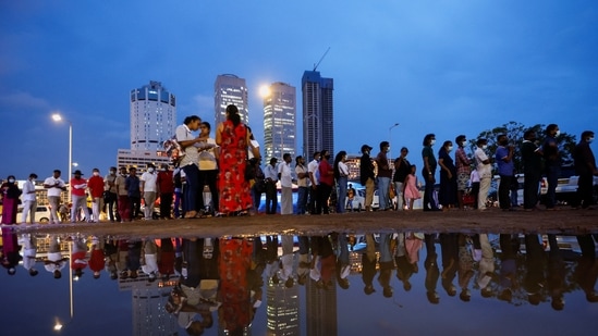 Demonstrators stand in a queue for food in a protest area, dubbed the Gota-Go village, as people gather in opposition to Sri Lanka's President Gotabaya Rajapaksa near the Presidential Secretariat, amid the country's economic crisis, in Colombo, Sri Lanka.(REUTERS)