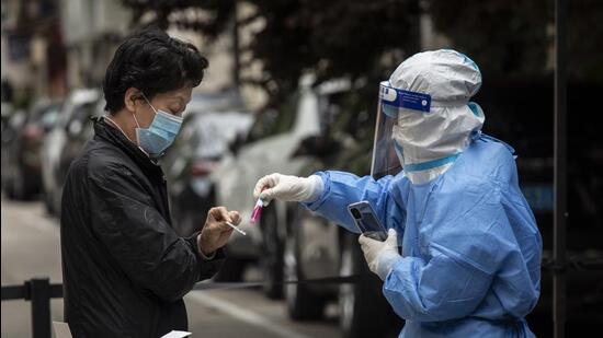 Residents take part in a round of Covid-19 testing during a lockdown in Shanghai, China, on Sunday. (Bloomberg)