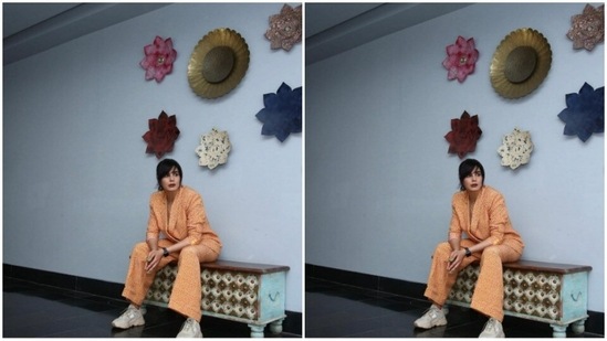Kirti paired an orange and yellow animal printed blazer with a pair of formal trousers of the same print. In grey sneakers, she perfectly blended casual and formal vibes together.(Instagram/@iamkirtikulhari)